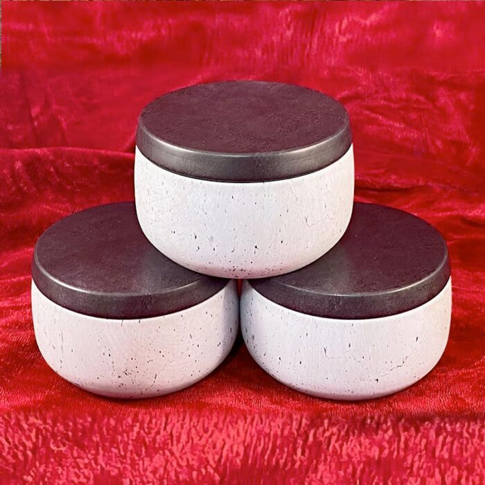 Soy candles in neutral decorative tins.