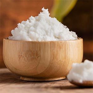 A wooden bowl full of shea butter